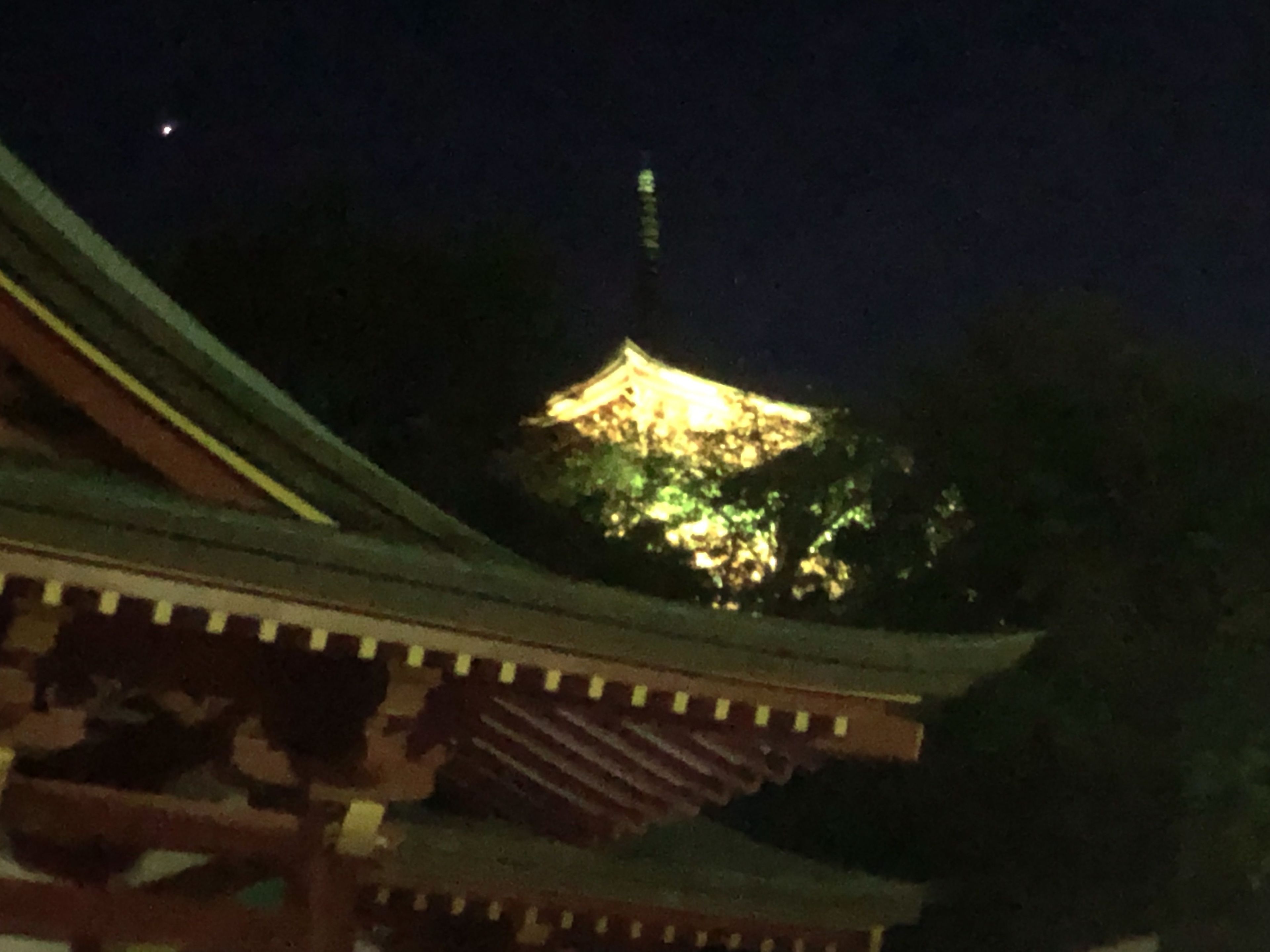 A traditional building with a curved roof and a prominent tower.
