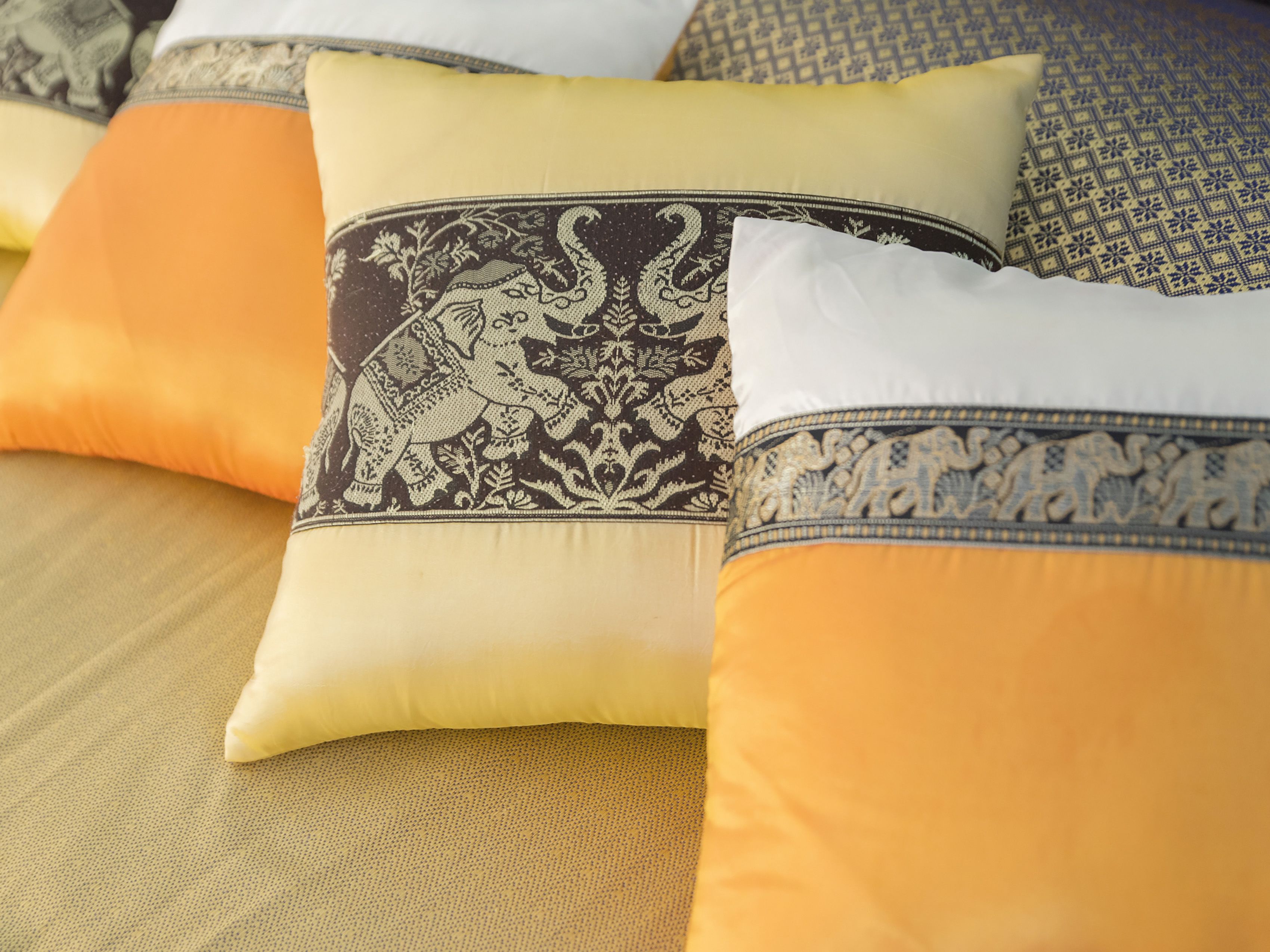 A close-up of a sofa with patterned cushions.