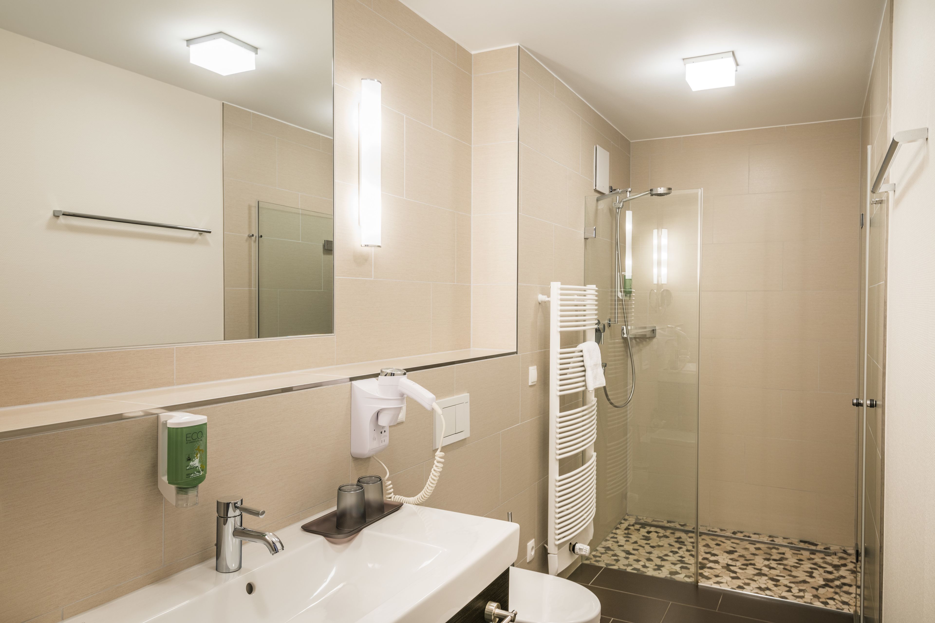 shower, hair dryer, slippers, towels