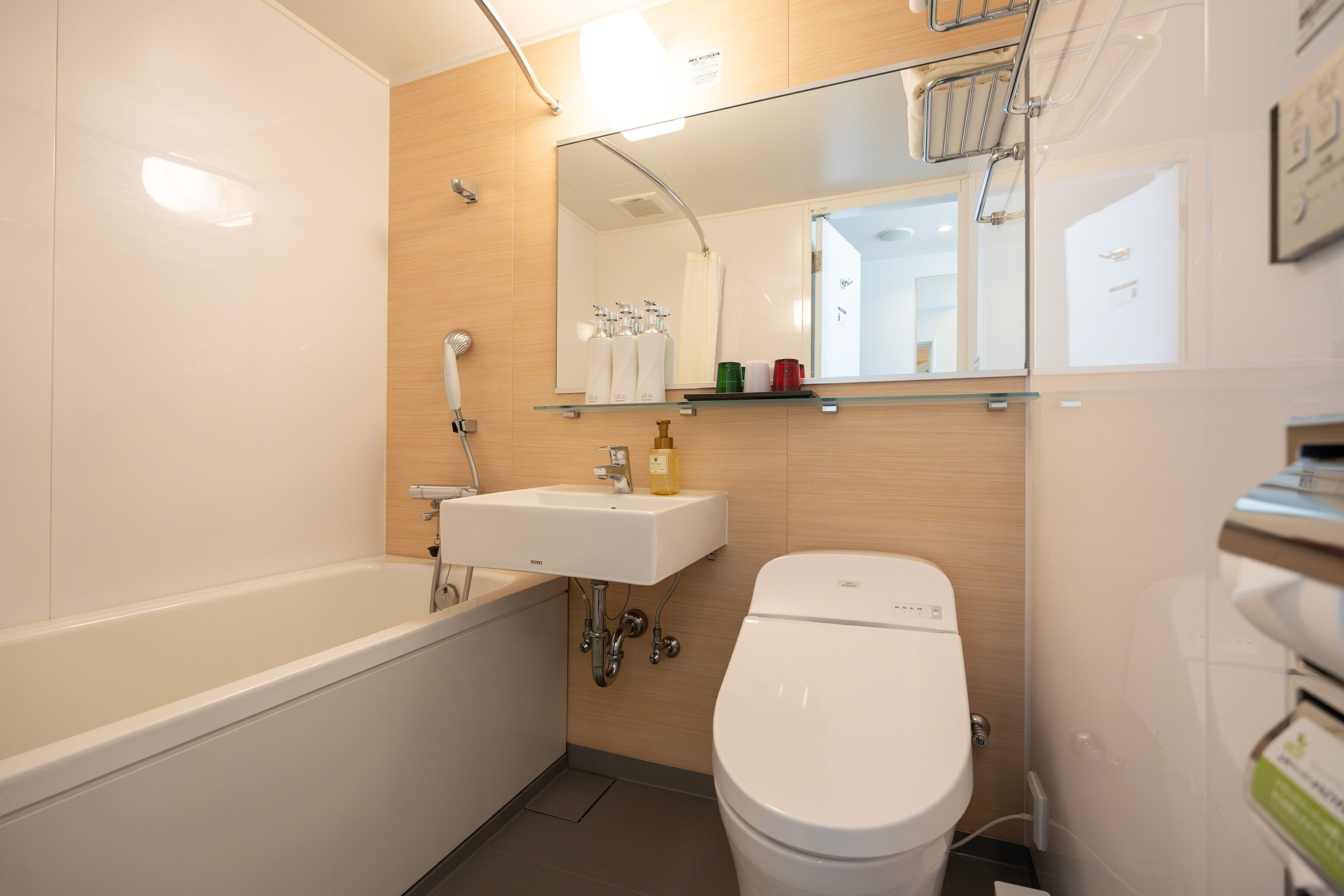 A modern bathroom with a bathtub, a sink, and a toilet.