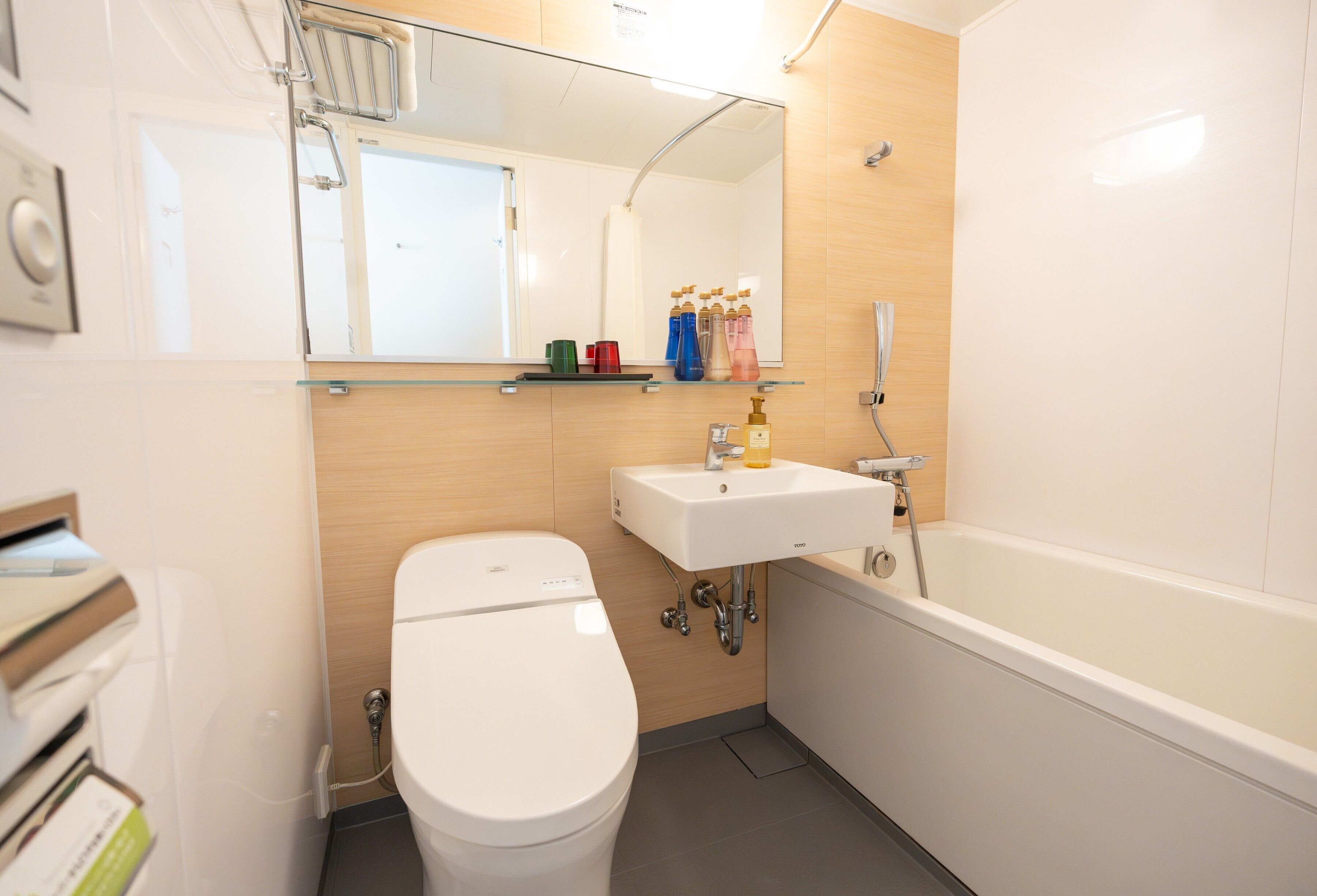 A modern bathroom with a toilet, sink, and bathtub.