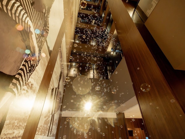 A multi-level interior with a modern design, featuring a staircase and a bubble effect.