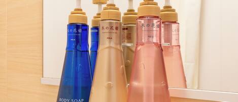 A display of body care products including body soap, conditioner, and shampoo.