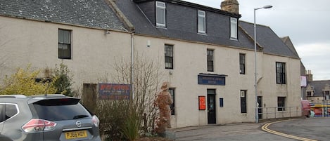 A building with a sign for 'Meldrum Arms Hotel'.