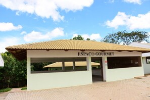 A building named ESPACO GOURMET with a tiled roof and a covered entrance area. - Reserva Caldas Lacqua 2 (Caldas Novas)