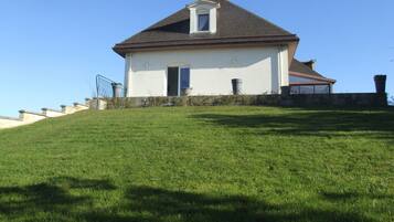 A house with a sloped roof, a front door, and a small window.