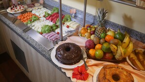A buffet with various food items including fruits, vegetables, and desserts. - Pousada Recanto dos Corais (Ipojuca)