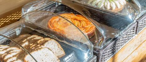 A bakery display with various breads and pastries.