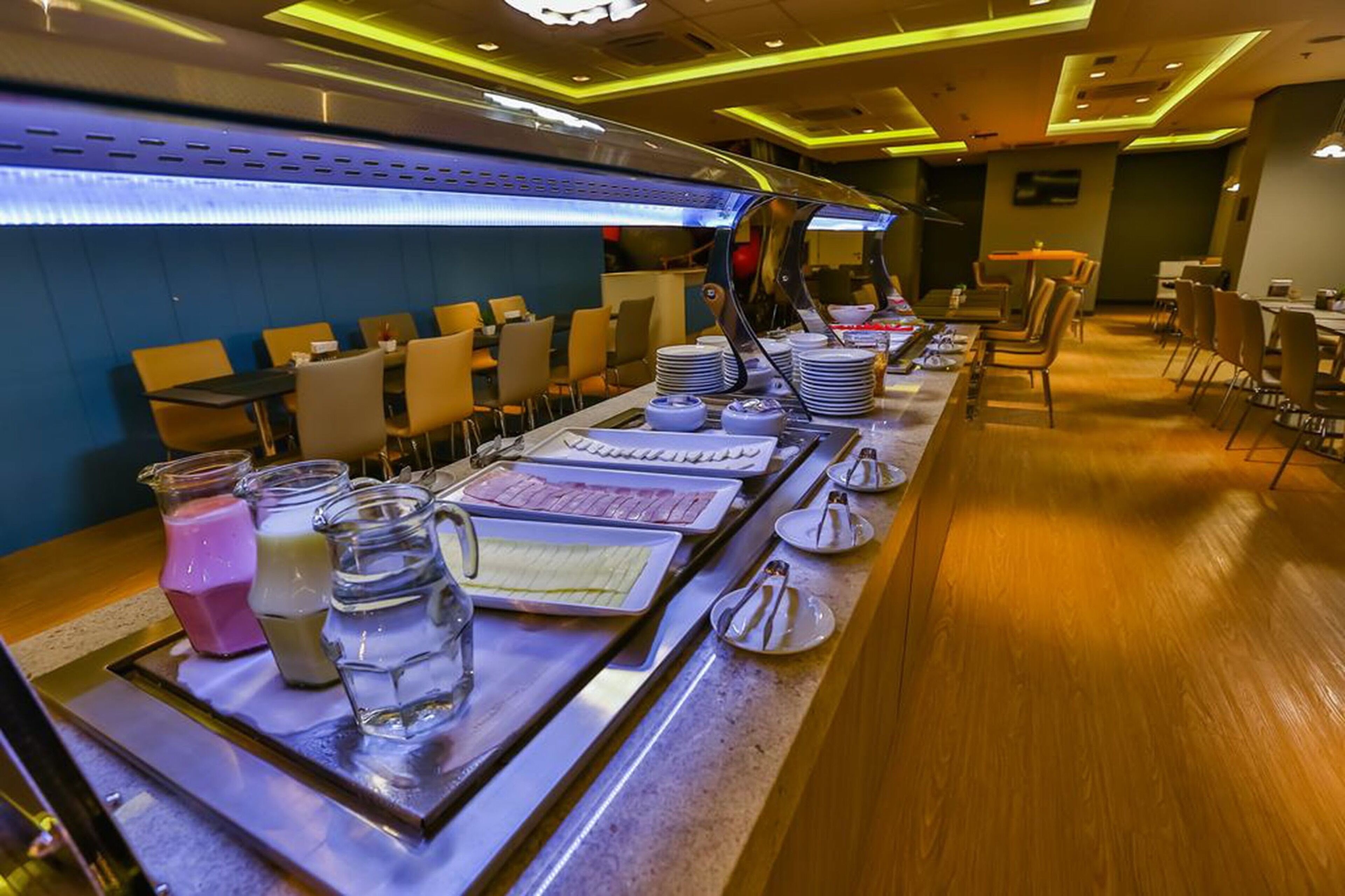 A buffet setup with various food items and beverages.