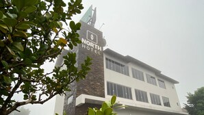 A hotel with a prominent sign reading "NORTH HOTEL" on a brick facade. - North Hotel (Chapecó)