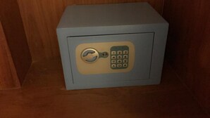 A small, light blue safe with a combination lock and keypad. - Same Same Guesthouse (Patong)