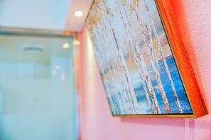 A framed artwork on a wall with a glass door in the background. - The Wind B&B (Budai)