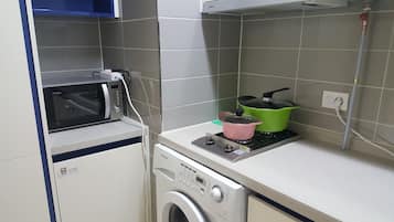 Family Apartment, Multiple Beds | Private kitchen | Fridge, microwave, stovetop, coffee/tea maker