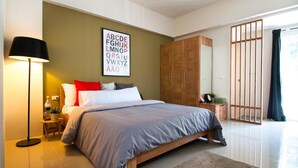 A modern bedroom with a bed, a nightstand, a lamp, a wardrobe, and a large window with a view. - Krit Place (Nonthaburi)