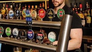 A bar with multiple beer taps and a bartender. - Royal Hotel Ryde (Ryde)