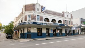 A historic building with the Royal Hotel and Carlton Dry signage, featuring arched windows and a classic facade. - Royal Hotel Ryde (Ryde)