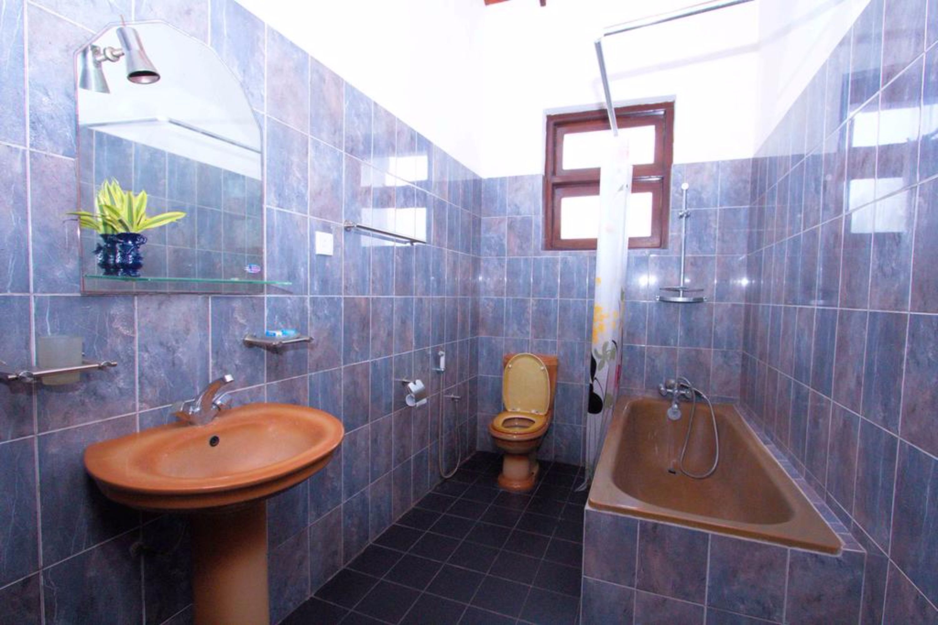 A bathroom with a sink, toilet, and bathtub.