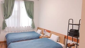Twin Room | Iron/ironing board, bed sheets