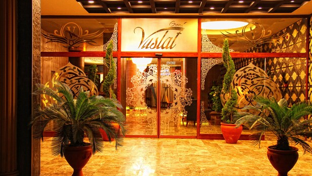 A hotel entrance with ornate glass doors, potted plants, and a sign reading "Vistal". - Grand Vuslat Hotel (Trabzon)