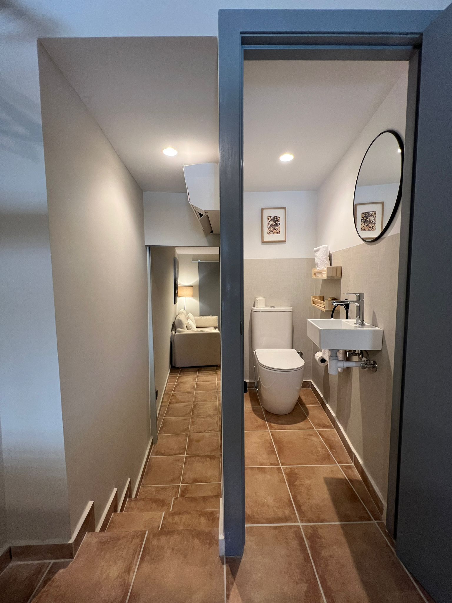 A modern bathroom with a toilet, sink, and shower area.