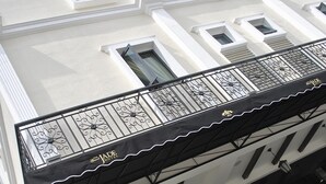 A building with a white facade, multiple windows, and a balcony with decorative iron railings. - The Grand Jade Hotel (Johor Bahru)