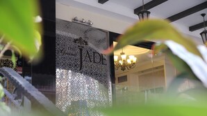 A hotel entrance with a decorative glass door and a chandelier visible inside. - The Grand Jade Hotel (Johor Bahru)