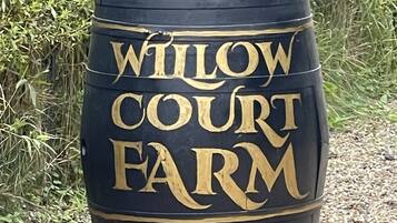 A black barrel with the text "WILLOW COURT FARM" in gold lettering.