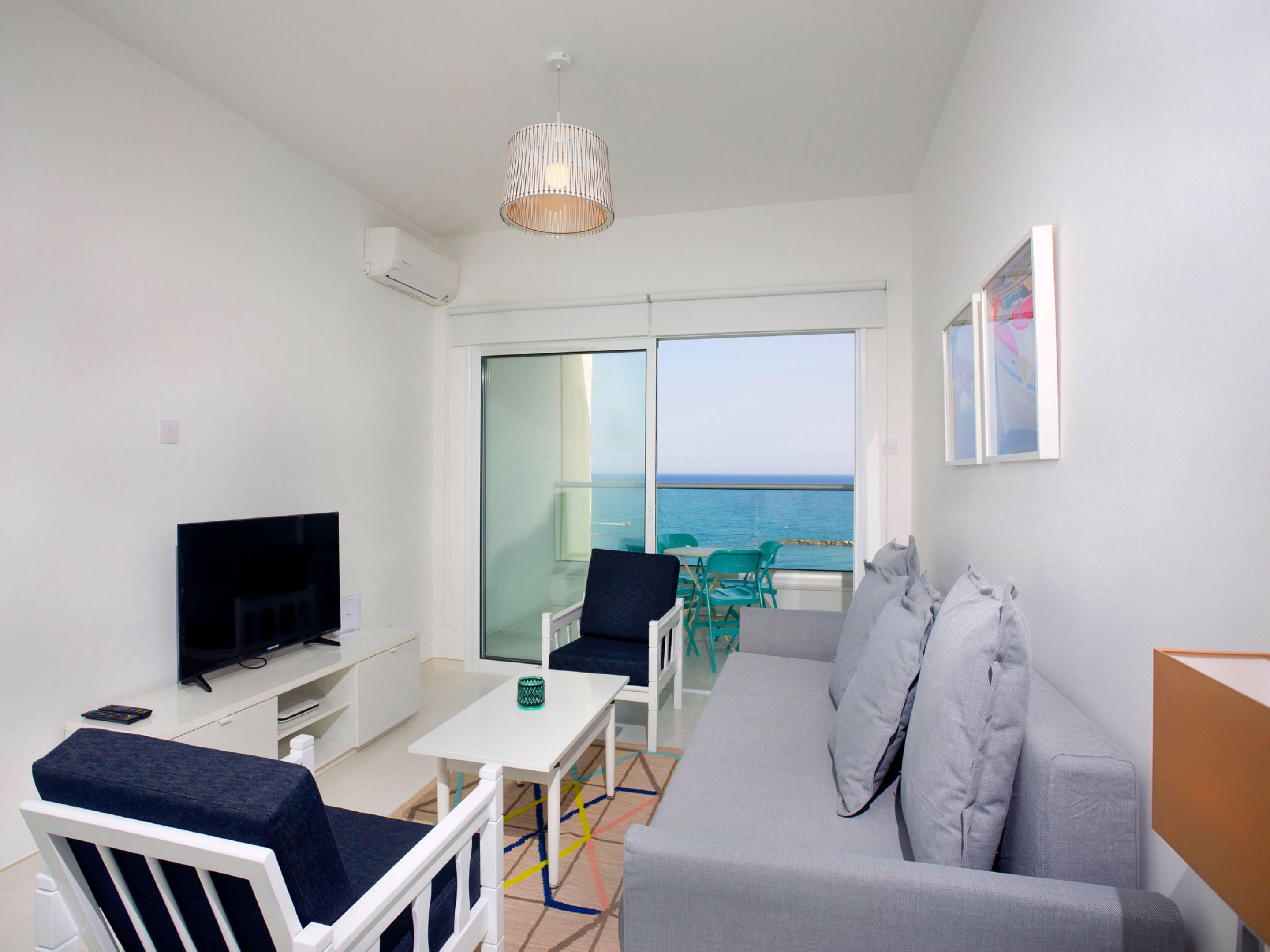 Deluxe Apartment, 2 Bedrooms, Beachfront | Living area | Flat-screen TV