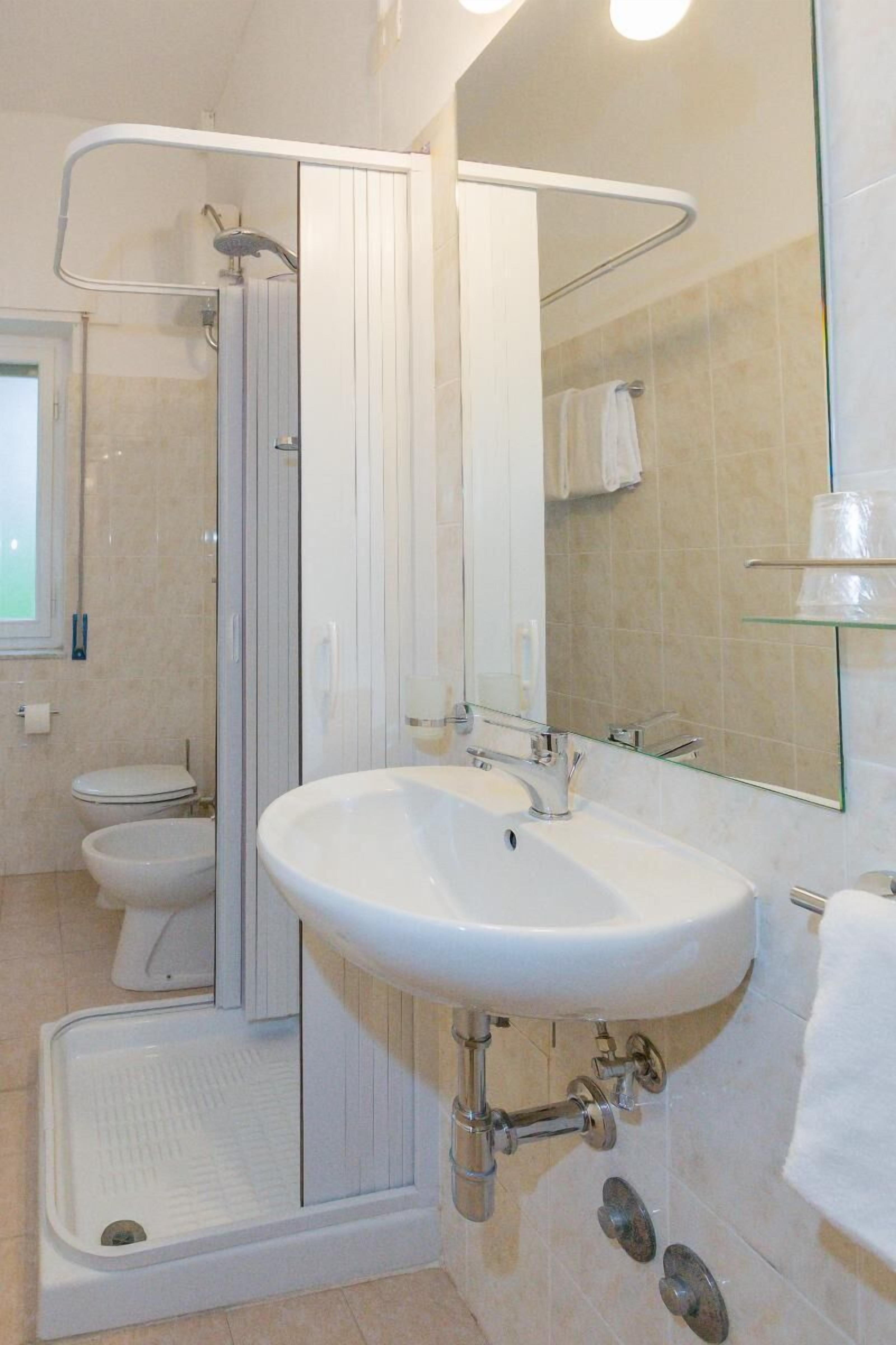 classic quadruple room, ocean view | bathroom | shower, hair dryer, towels