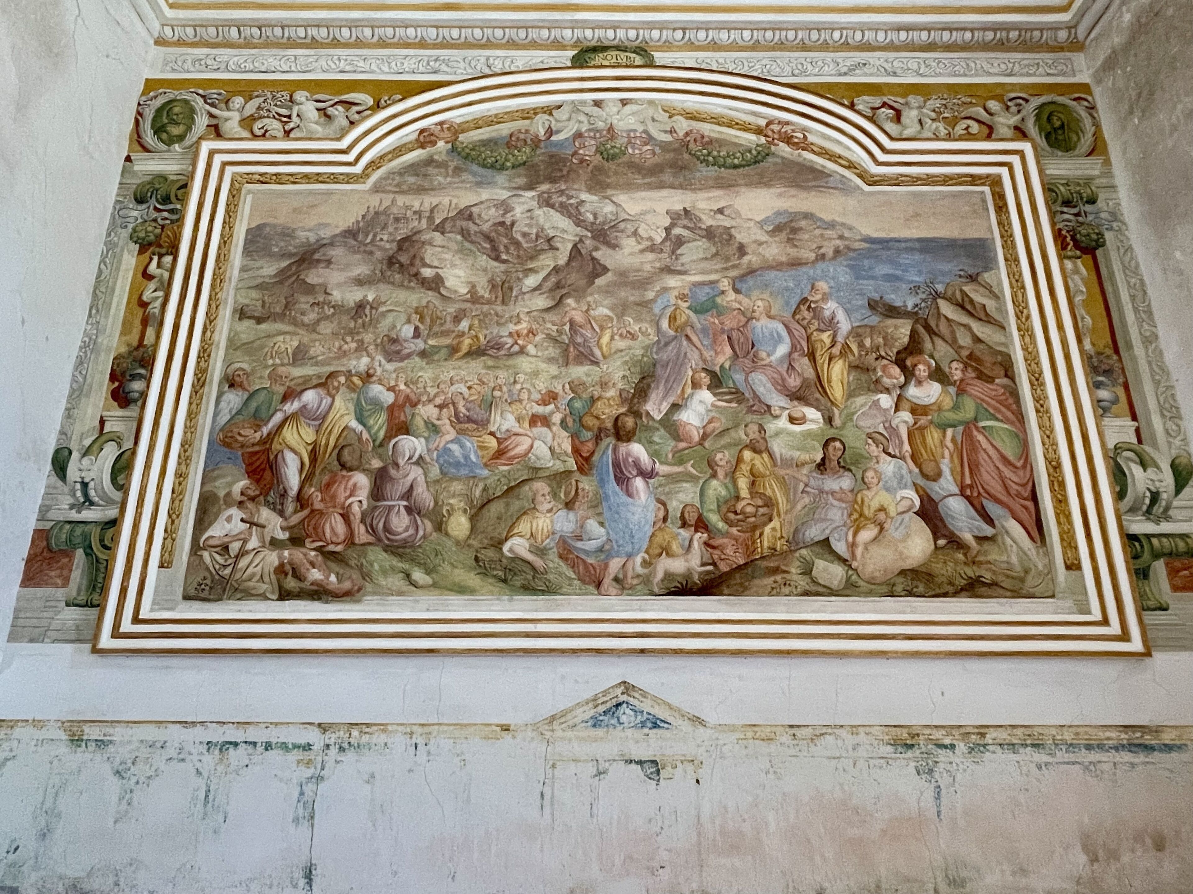 A fresco mural with classical figures and architectural elements.