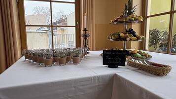 A table with chocolate mousse cups, a fruit display, and a sign indicating a chocolate dessert.