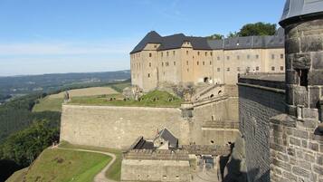 A large stone castle with multiple towers and a fortified wall.