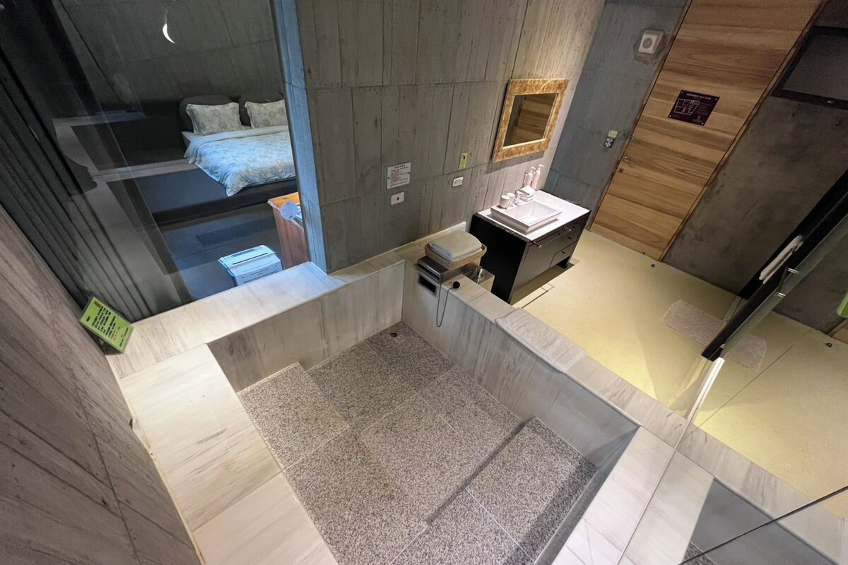 A modern bathroom with a shower, toilet, and sink.