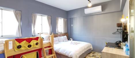 A bedroom with a bunk bed, a desk, and a chair.