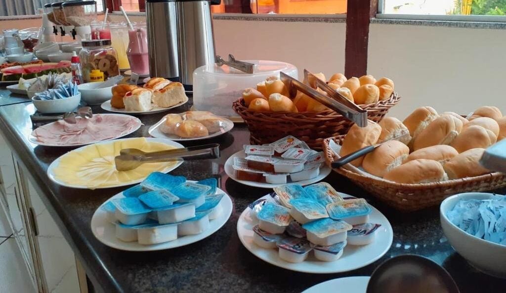 A buffet with various food items including bread, pastries, and dairy products.