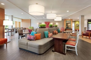 Enjoy meals in this stylish dining area with a long table, comfortable chairs, and a cozy sofa.