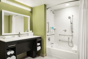 Enjoy a refreshing shower in the spacious bathroom with a walk-in shower and dual sink vanity.