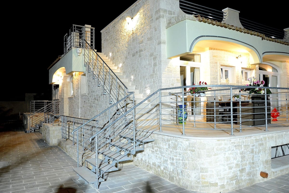 Un bâtiment en pierre avec un escalier menant à un balcon.