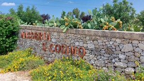 Eine Steinmauer mit einem Schild, auf dem "MASSERIA S. COSTINO" steht.