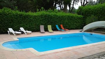 Seasonal outdoor pool, open 10:00 AM to 7:00 PM, pool umbrellas