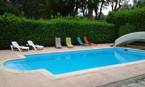 Seasonal outdoor pool, open 10:00 AM to 7:00 PM, pool umbrellas