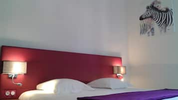 A hotel room with a red headboard, white bedding, and a zebra painting on the wall.