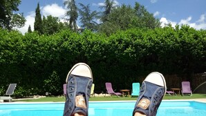 A poolside view with a clear blue sky, a pool, and a hedge in the background. - Logis Hôtel Le Domaine de la Régalière (Anduze)