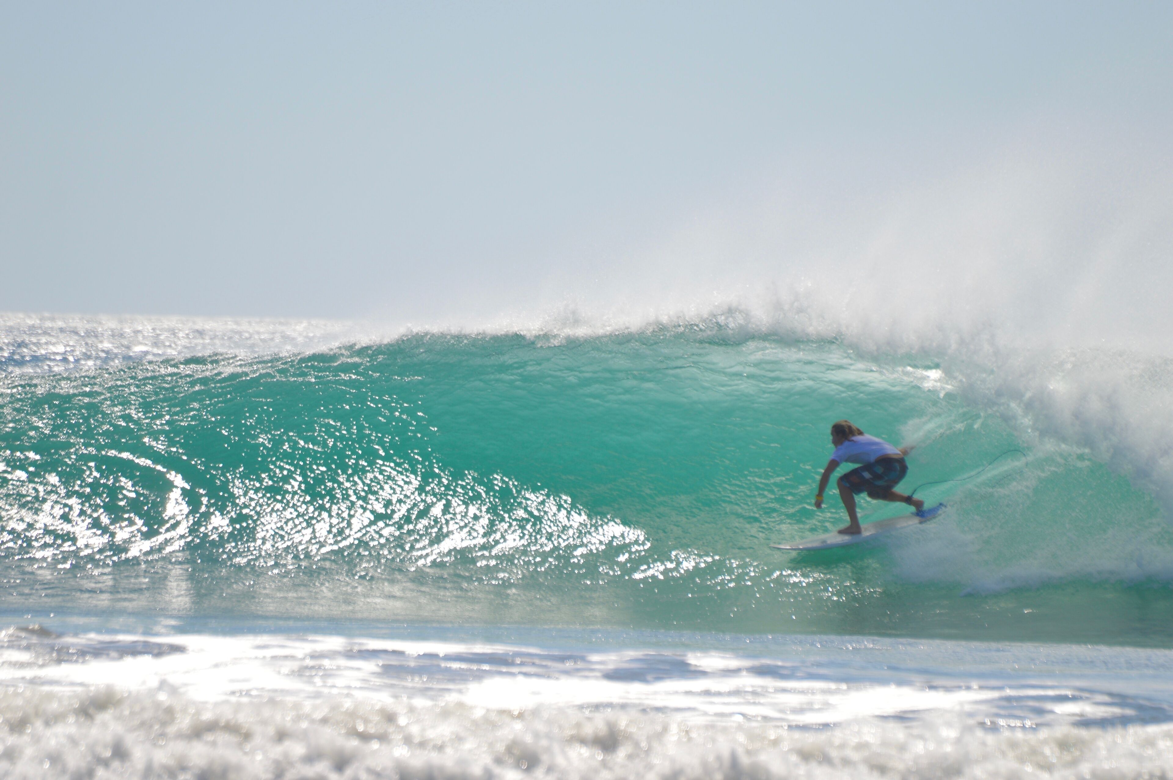 A surfer riding a large wave.