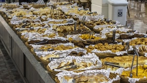 A buffet with various food items in wicker baskets, arranged on a counter.