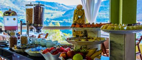 A buffet table with various food items and a coffee station.