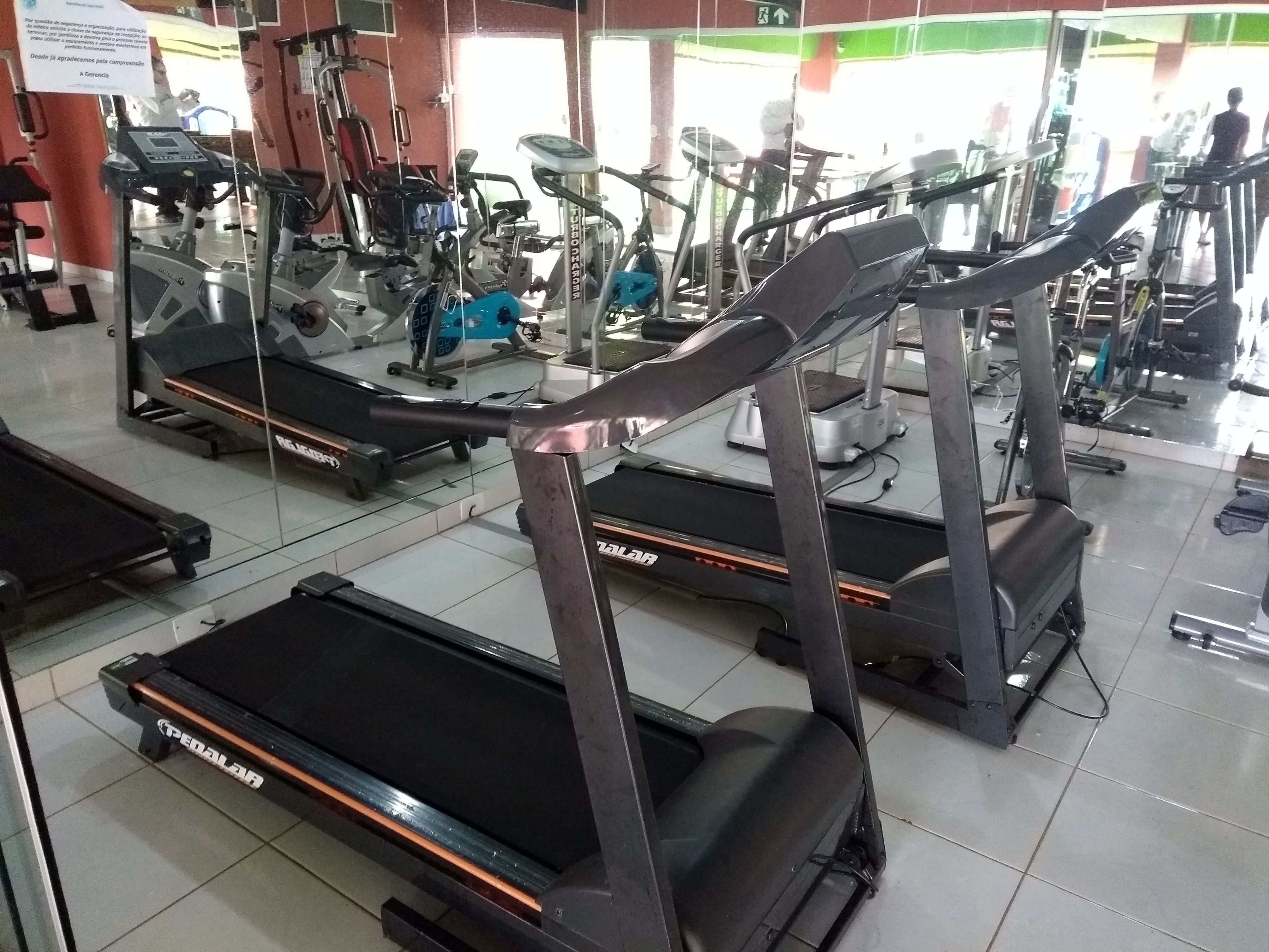 A gym with multiple treadmills, stationary bikes, and other fitness equipment.