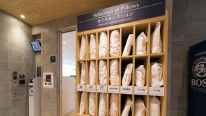 A selection of pillows in a store with a sign above them. - Just Inn Premium Nagoya Station (Nagoya)