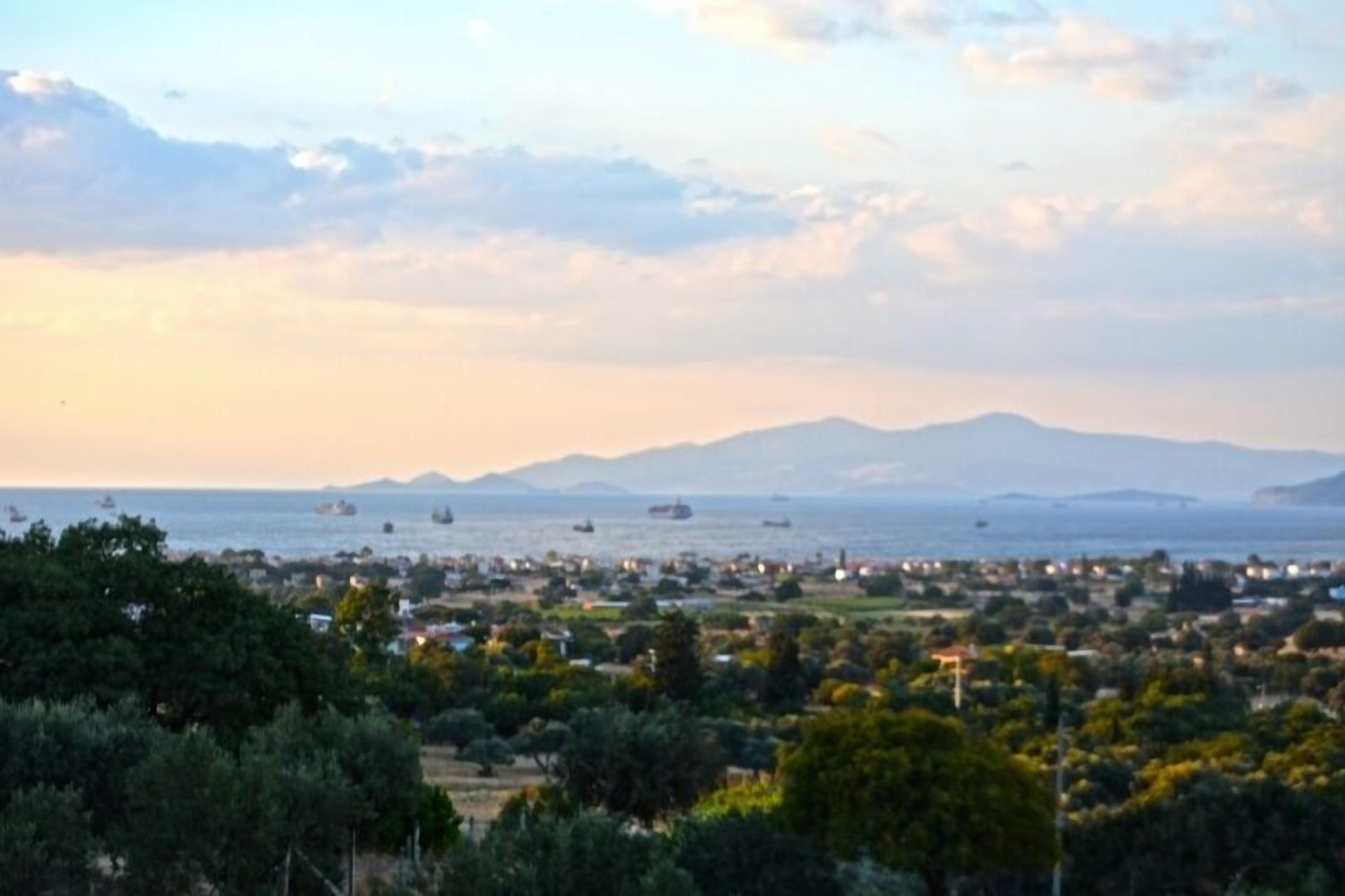 Un pueblo costero con vista al mar y montañas al fondo.