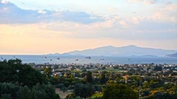 A coastal town with a view of the sea and mountains in the distance.